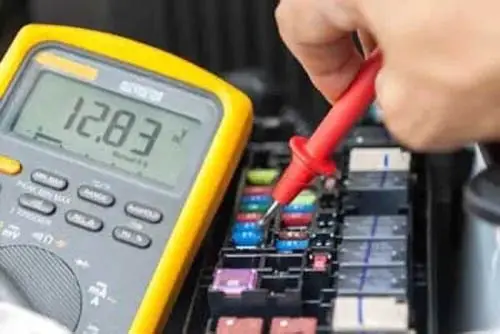 Checking The Voltage Level Of A Fuse In A Car With Multimeter