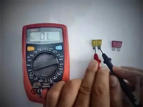Connecting The Tip Of Multimeter To Both Terminals Of The Fuse
